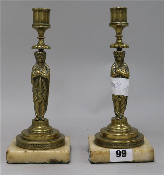 A pair of brass figurative candlesticks